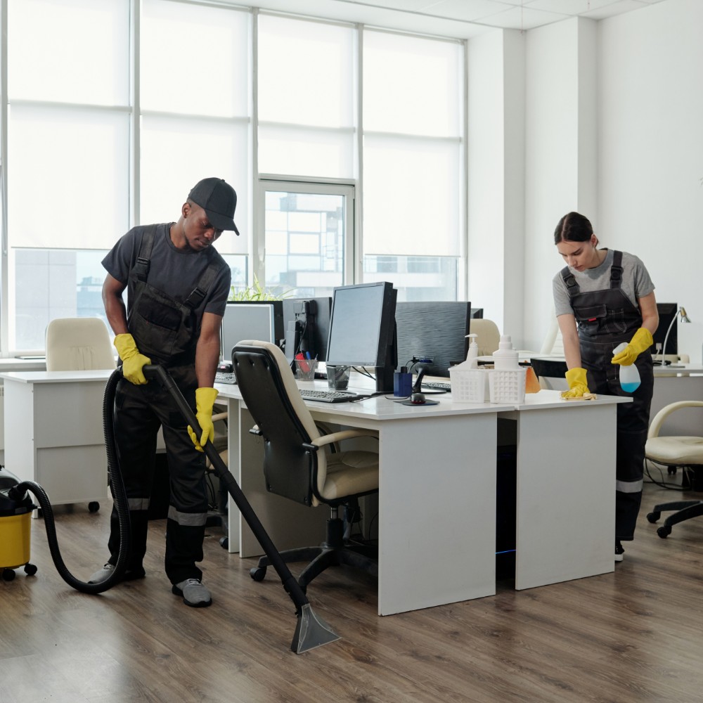 Professional cleaner vacuuming office floor
