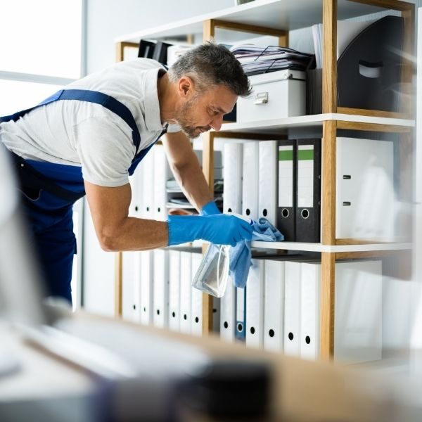 Professional cleaner dusting office fixtures in Southwestern PA